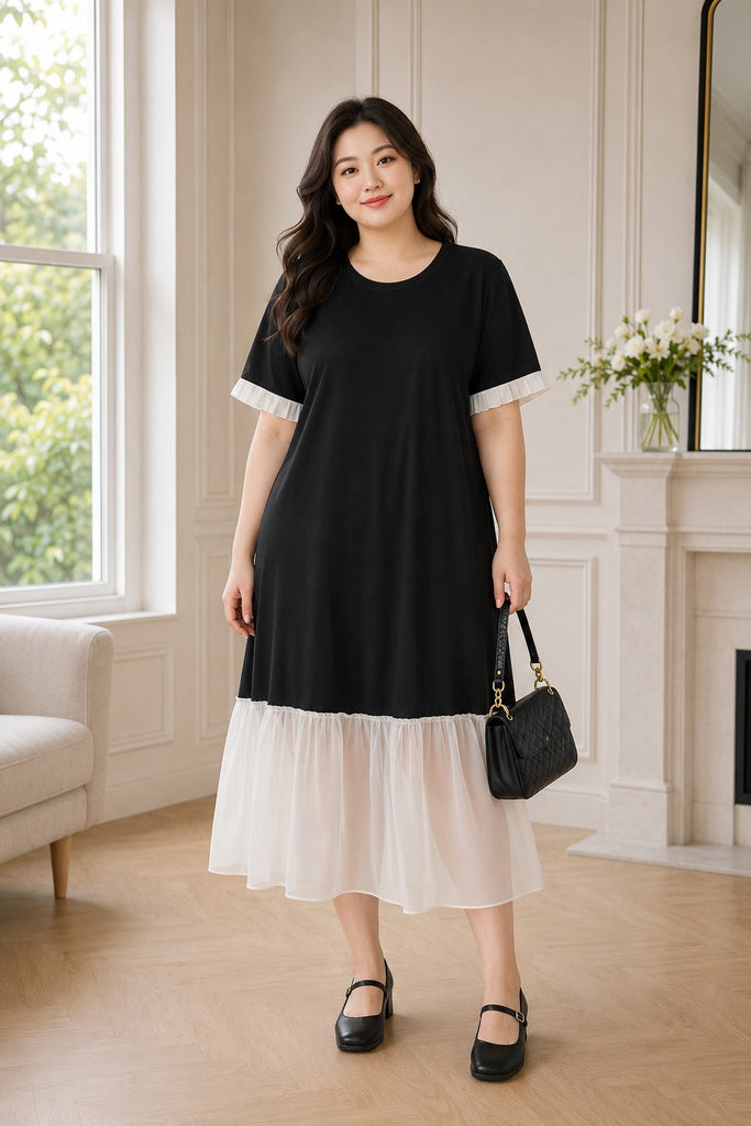 Plus size black drop waist short sleeve midi dress worn by model