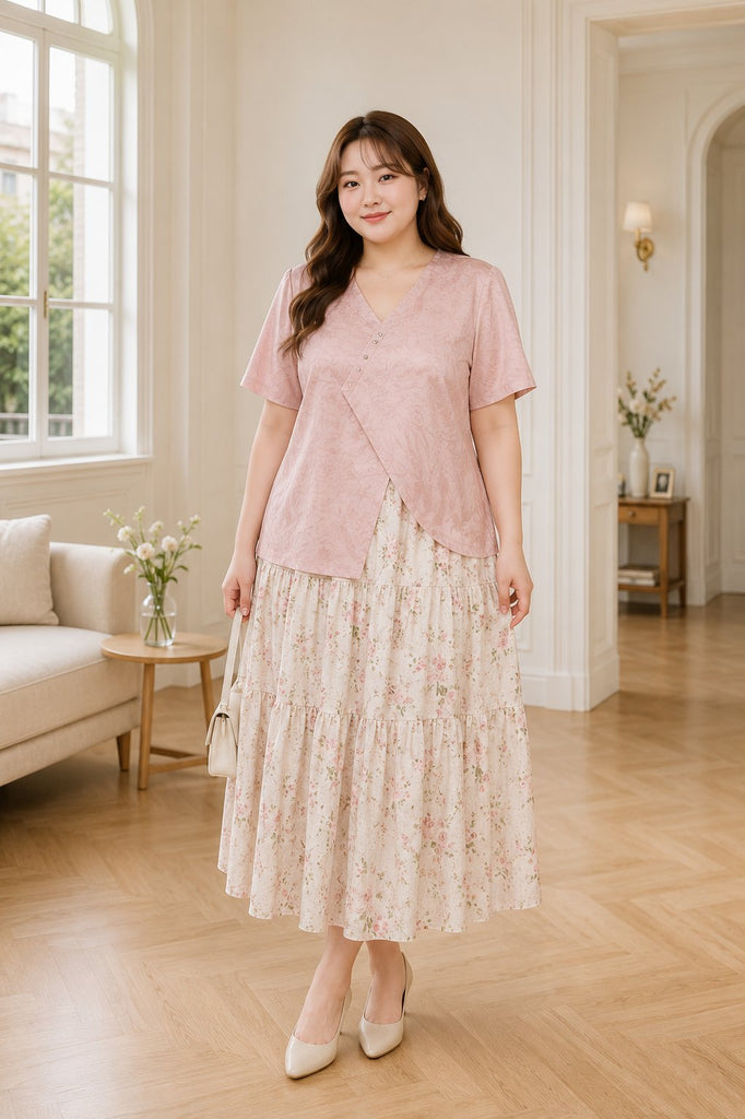 Plus size pink V neck blouse and floral tier midi skirt set worn by model
