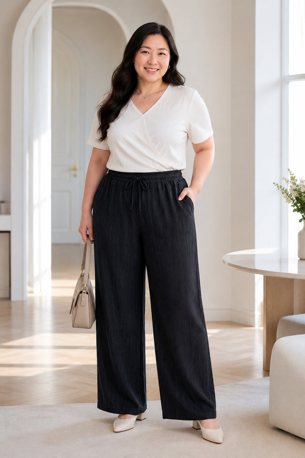 Plus size textured straight leg drawstring ankle pants in black front view